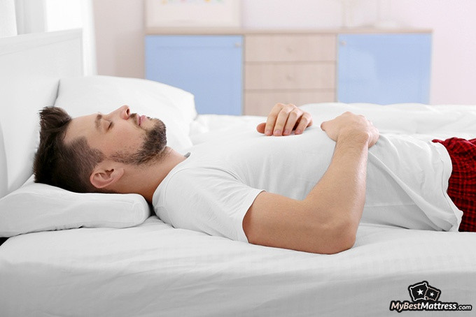 How to sleep on your back: a man sleeping on his back How to sleep on your back: a man sleeping on his back.